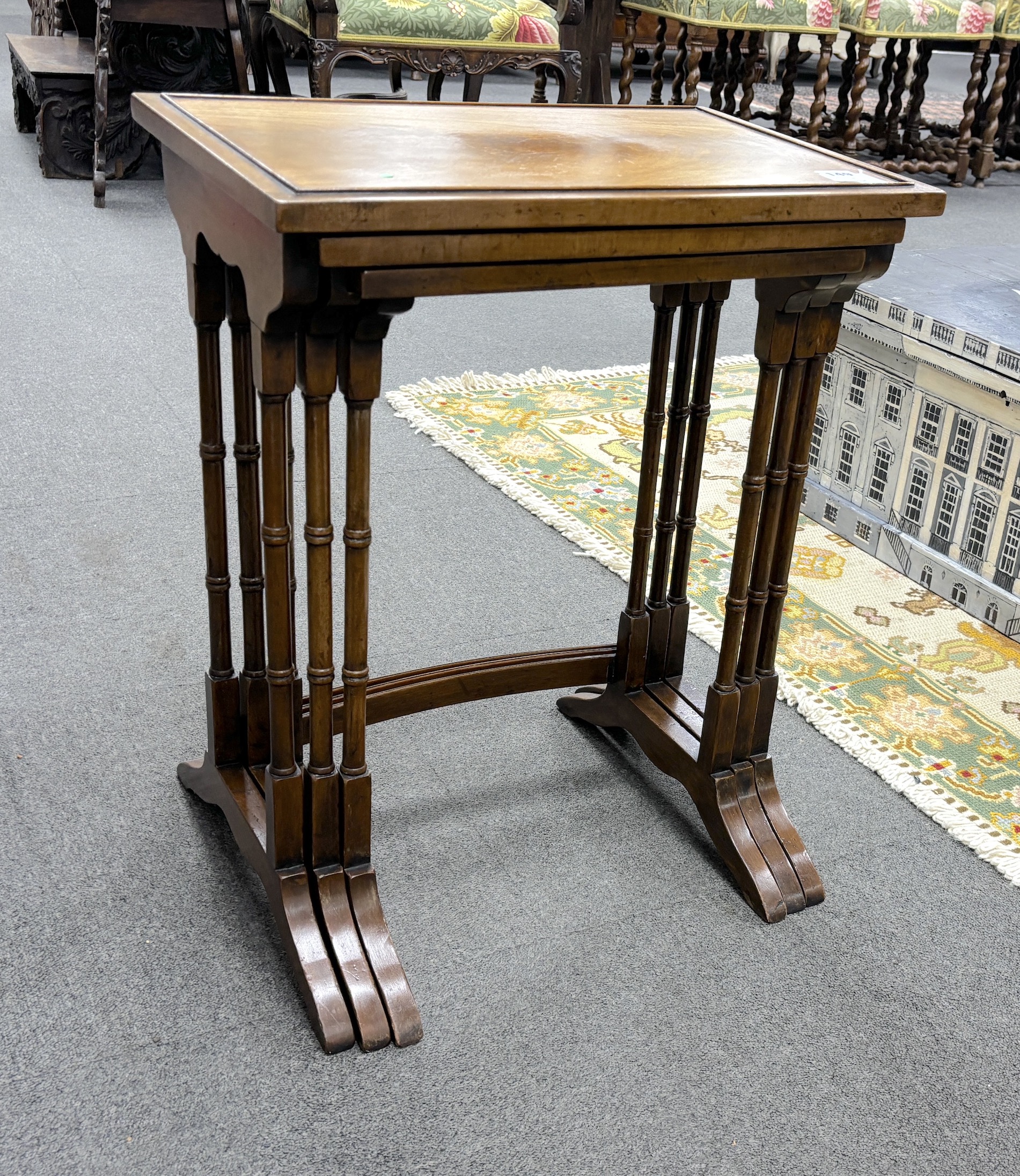 A nest of three Edwardian rectangular mahogany tea tables, on spindle turned legs, width 48cm, depth 33cm, height 60cm